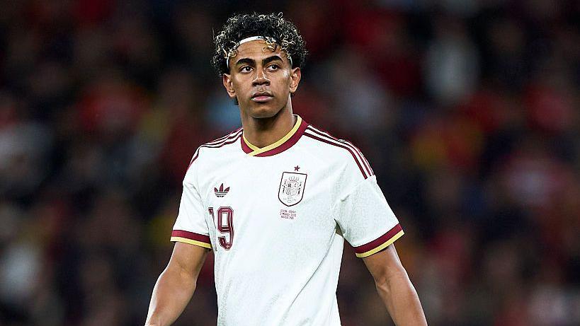 Lamine Yamal wearing a white Spain shirt