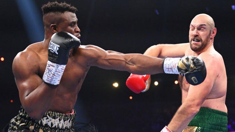 Francis Ngannou throws a punch at Tyson Fury