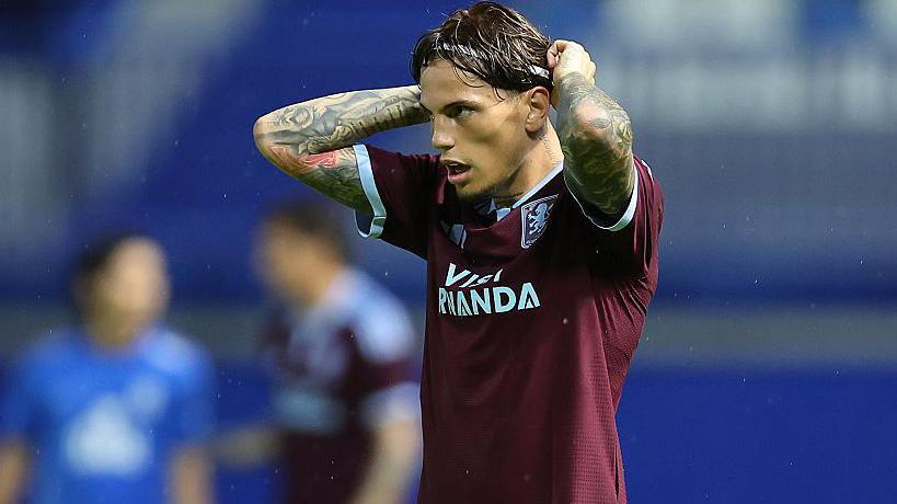 Alejandro Garnacho adjusts his headband while playing for Aston Villa in pre-season