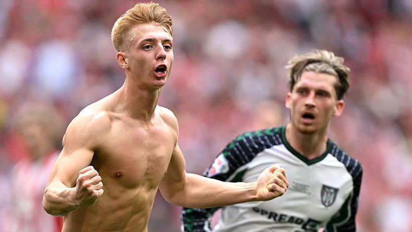 Tom Watson with his top off, runs away celebrating his Wembley winner