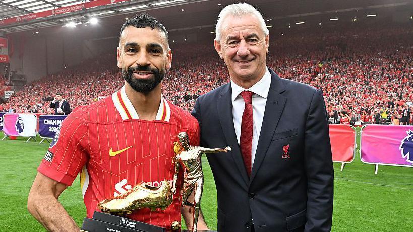 Former Liverpool striker Mohamed Salah (left) is presented with the Premier League Golden Boot winner 2024-25 award by Ian Rush