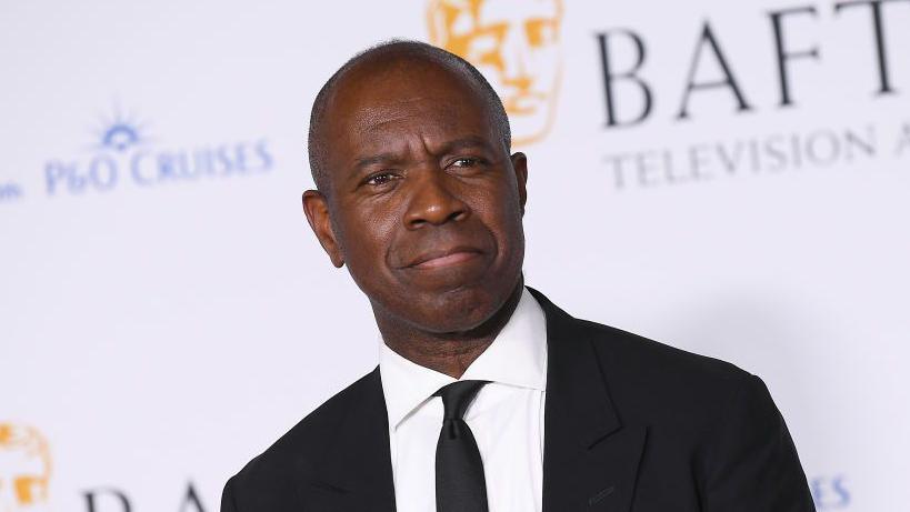 Clive Myrie is seen in a black suit and tie. He is pictured on the red carpet while attending the Bafta ceremony in London.