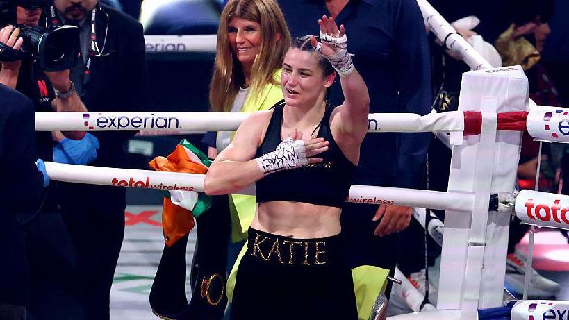 Katie Taylor waves to the crowd from the ring