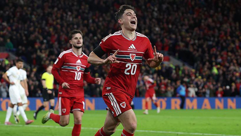Dan James celebrates after scoring for Wales against North Macedonia.