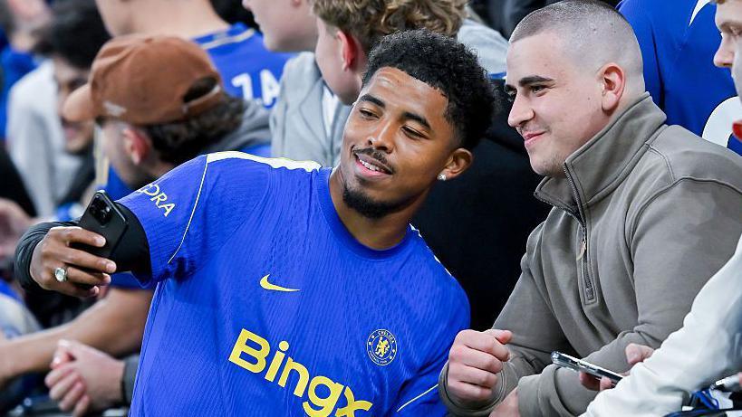 Wesley Fofana poses for a selfie with a fan