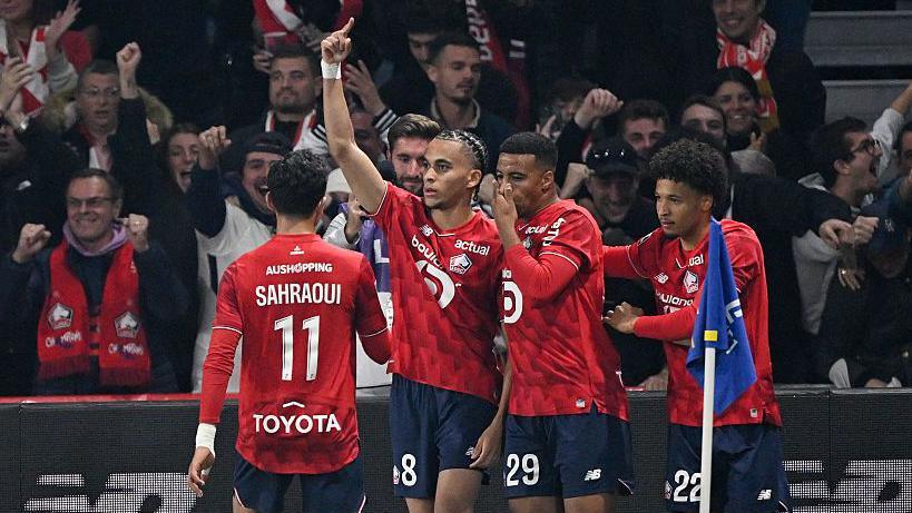 Ethan Mbappe celebrates his Lille equaliser with team-mates