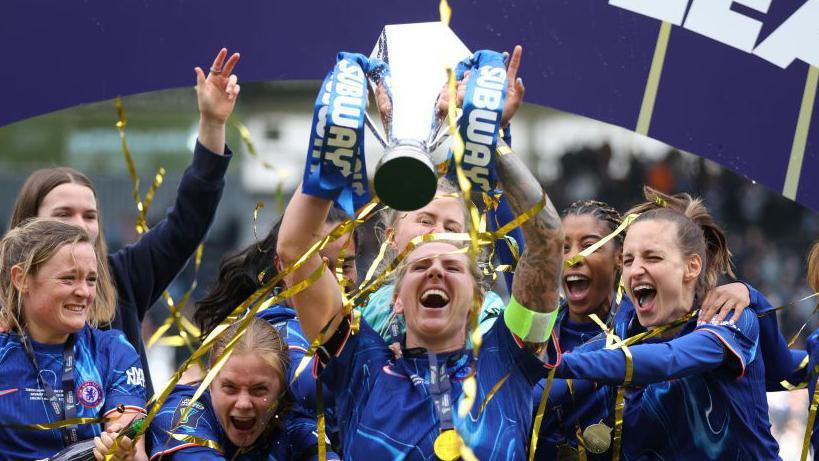 Chelsea captain Millie Bright lifts the Women's League Cup. 