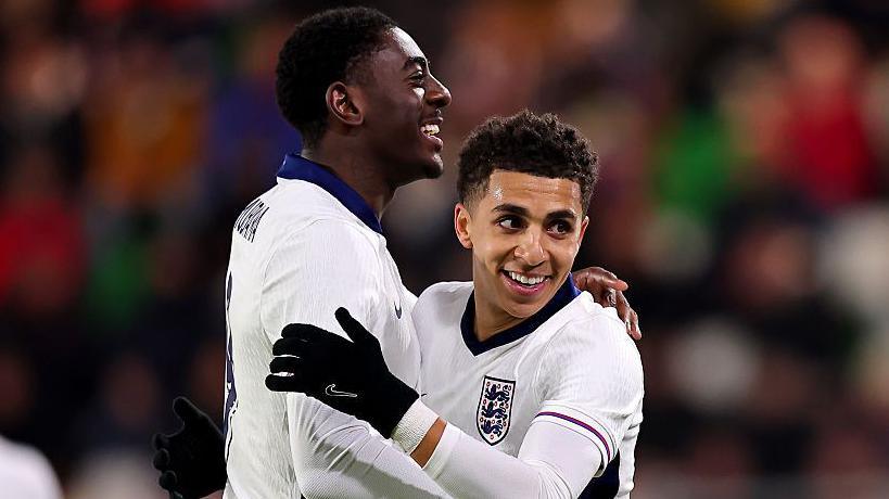 Divin Mubama and Rico Lewis celebrate an England goal