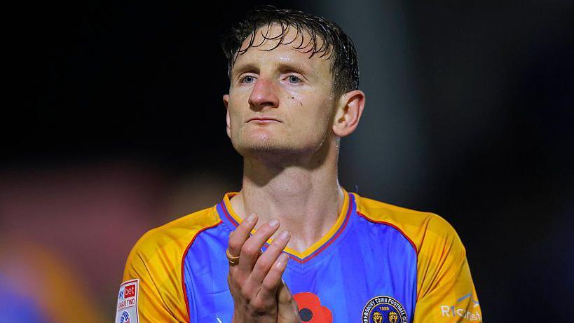 Shrewsbury Town defender Will Boyle applauds supporters