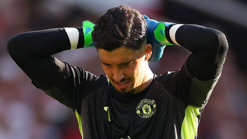 Man Utd goalkeeper Altay Bayindir with his hands on his head