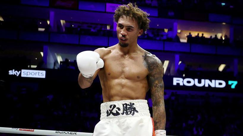 Ben Wittaker points his white glove in the ring