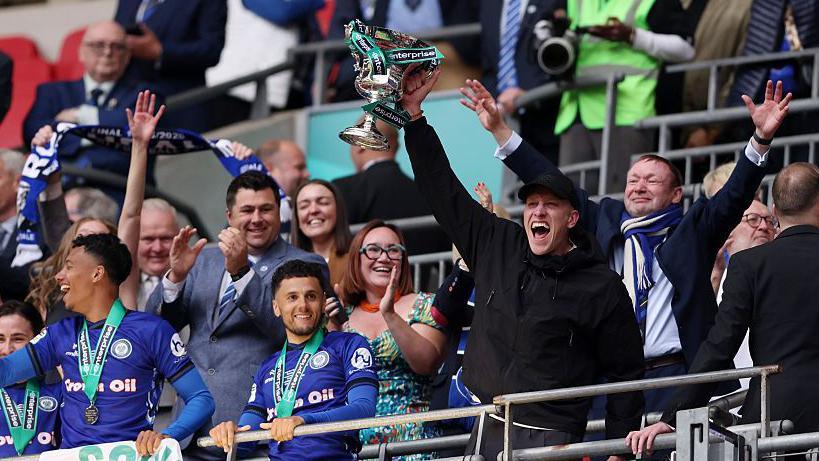 Jimmy McNulty lifts the National League promotion Final trophy at Wembley