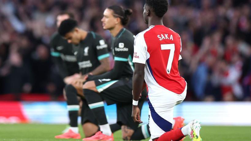 Arsenal footballer Bukayo Saka is joined by Liverpool players Darwin Nunez and Luis Diaz in taking the knee to oppose discrimination before the Premier League match at Emirates Stadium