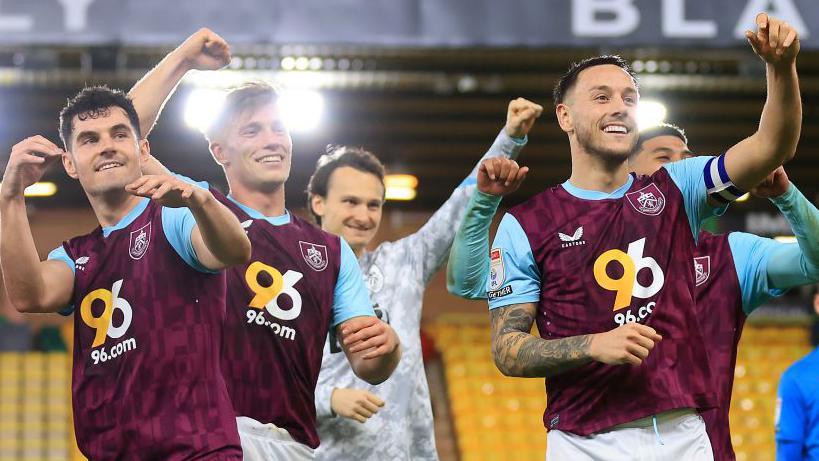 Burnley players celebrate in front of their fans