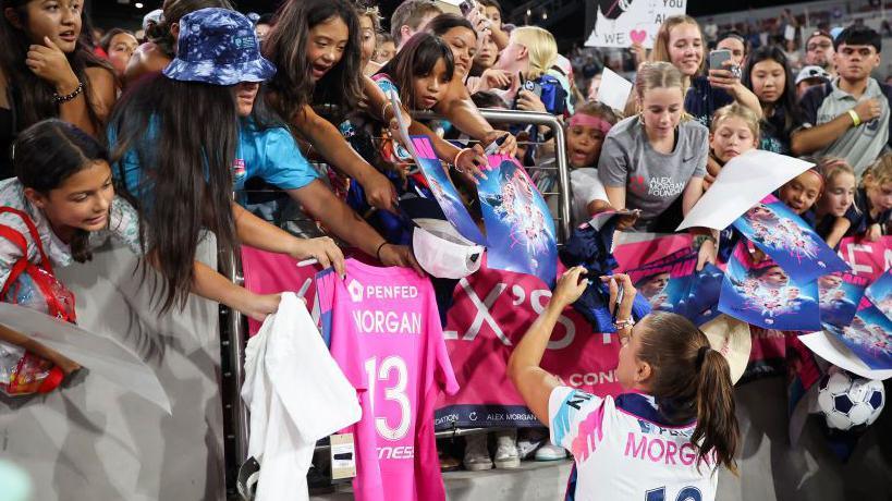 Alex Morgan signs autographs 