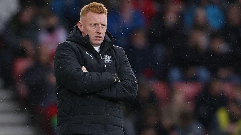 Will Still stands on the touchline with his arms crossed