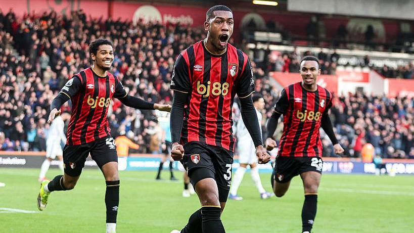 Rayan celebrates an equaliser for Bournemouth as team-mates rush to join him