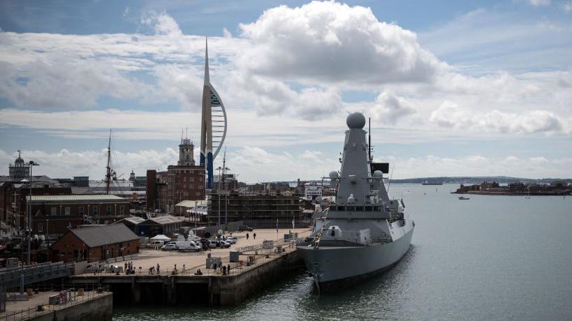 HMS Diamond is pictured from the flight deck of HMS Queen Elizabeth on August 16, 2017 in Portsmouth, England. Portsmouth's skyline, including the spinnaker, is to the left of the ship.