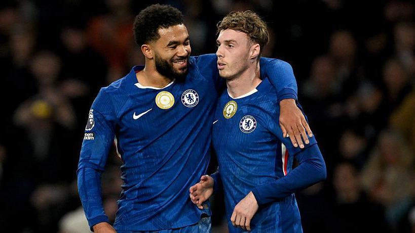 Reece James putting his arm around Cole Palmer