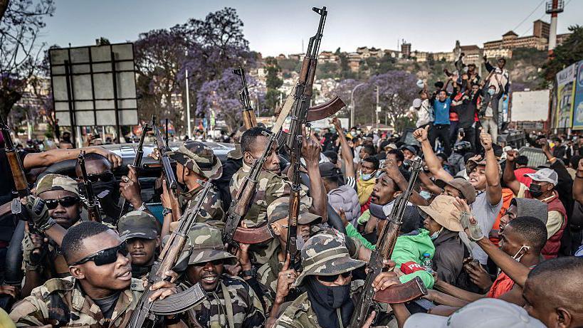  Members of a section of the Malagasy army ride on a pickup truck to secure the area around Lake Anosy as protesters celebrate their arrival following clashes between demonstrators and security forces during protests calling for the resignation of President Andry Rajoelina in Antananarivo, on October 11, 2025