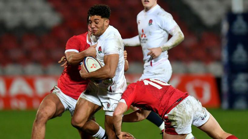 Gabriel Hamer-Webb of England is tackled by Sam Costelow of Wales during the U20s Six Nations match between England and Wales at Kingsholm Stadium on March 06, 2020