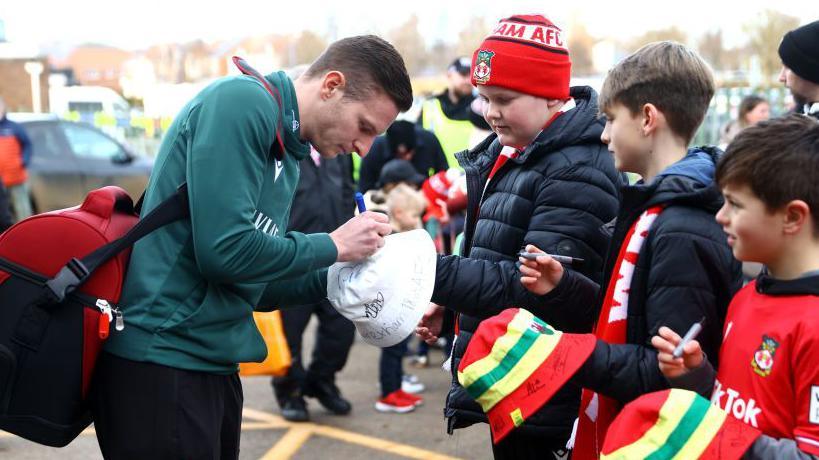 Paul Mullin signs autographs for Wrexham fans