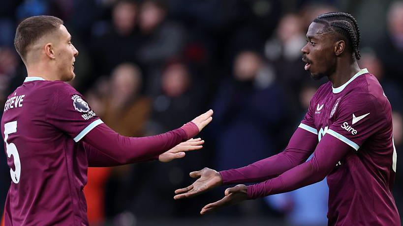 Maxime Esteve congratulates Axel Tuanzebe after he equalised for Burnley against Spurs at Turf Moor