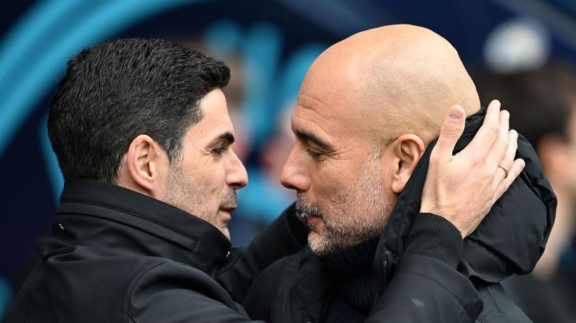 Arsenal manager Mikel Arteta embracing Manchester City boss Pep Guardiola