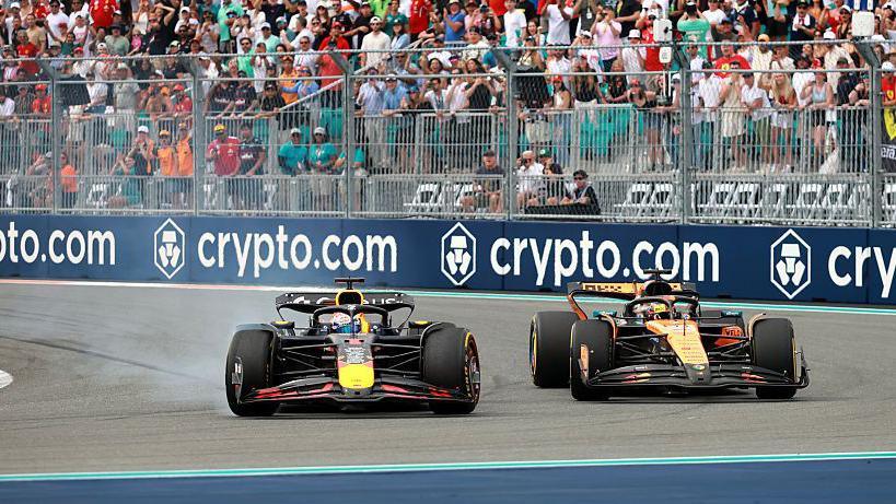 Max Verstappen locks up his Red Bull as Oscar Piastri moves alongside him to challenge for the lead