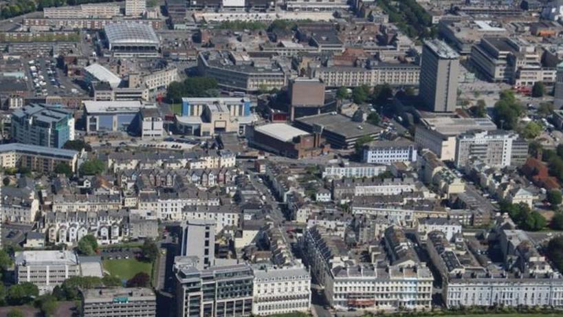 An aerial shot from above of Plymouth city centre, with different height buildings