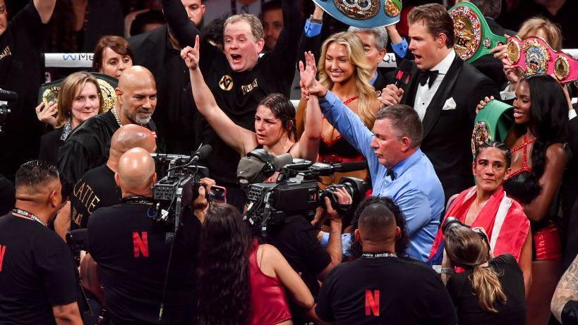 Katie Taylor celebrates as Amanda Serrano looks away in disgust