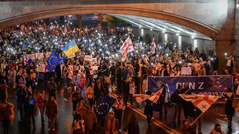 Protesters march during a rally against the controversial "foreign influence" bill in Tbilisi 