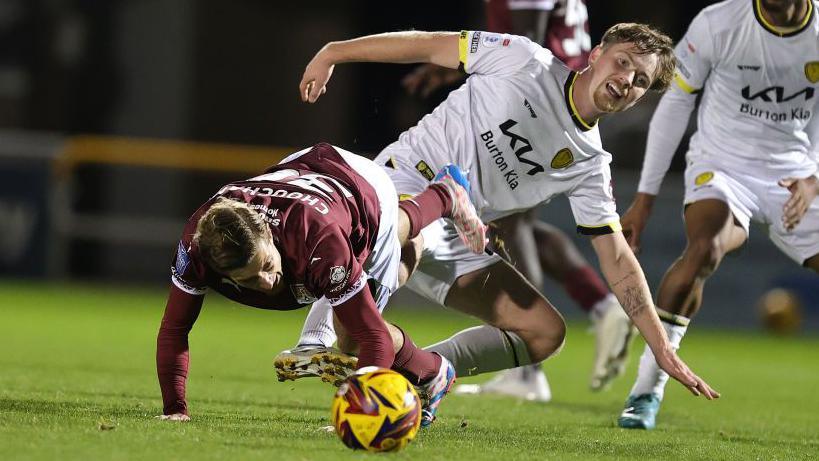 Alex Bannon who has joined Derry City on loan pictured making a tackle for Burton Albion in their game against Northampton Town.