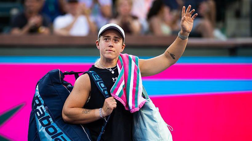 Sonay Kartal waves her left arm towards the crowd as she leaves the court at Indian Wells.