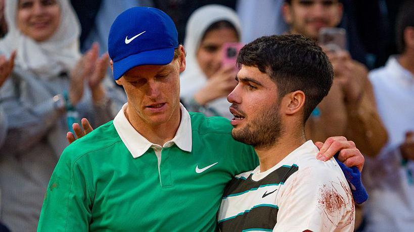 Jannik Sinner and Carlos Alcaraz hug after their epic French Open final
