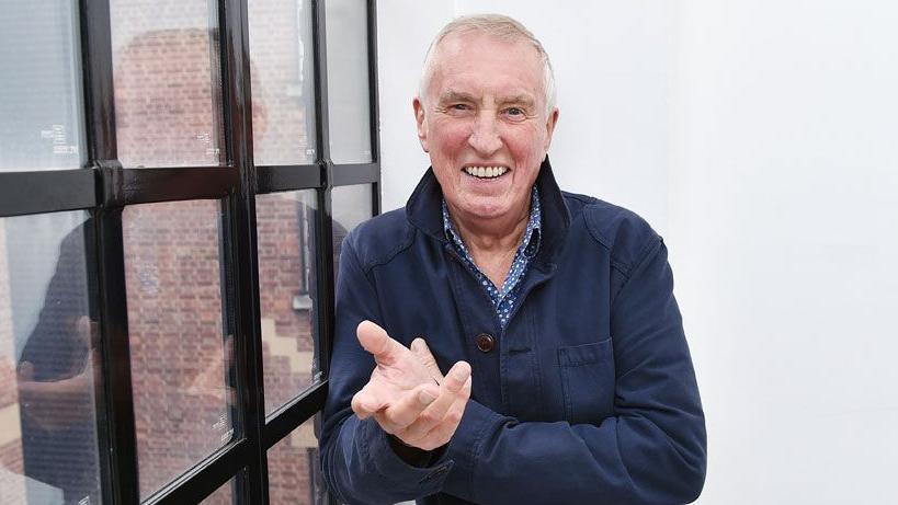 Radio 2 presenter Johnnie Walker, wearing a blue jacket against a white wall