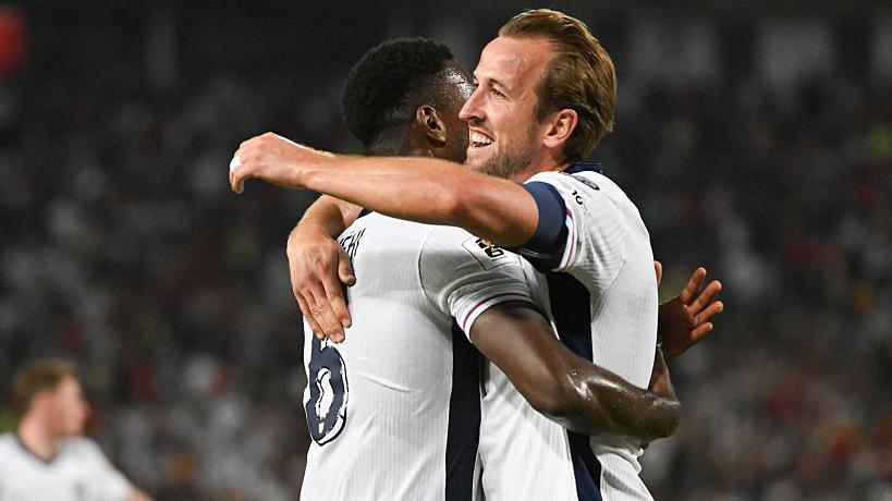 Harry Kane (R) celebrates with Marc Guehi
