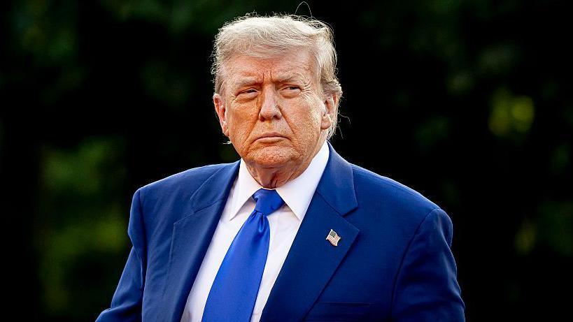 President of the United States Donald Trump wearing a blue suit and a blue tie at the NATO summit in June 2024.