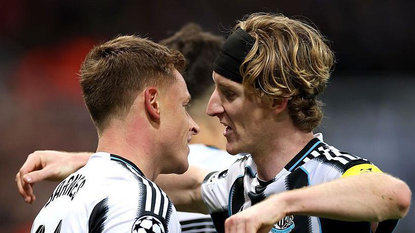 Anthony Gordon and Harvey Barnes celebrate after the substitute scores in Newcastle United's game against Benfica at St James' Park on 21 October, 2025