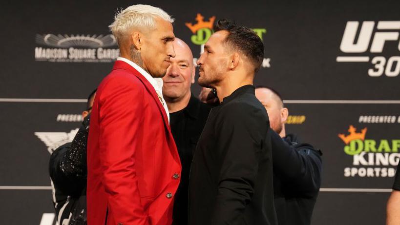 Charles Oliveira wears a red suit for his face-off with Michael Chandler