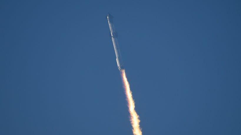 Starship rocket launching into space with trail of fuel behind it