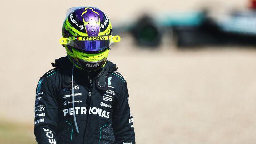 Lewis Hamilton walks away from his beached Mercedes after retiring from the United States Grand Prix