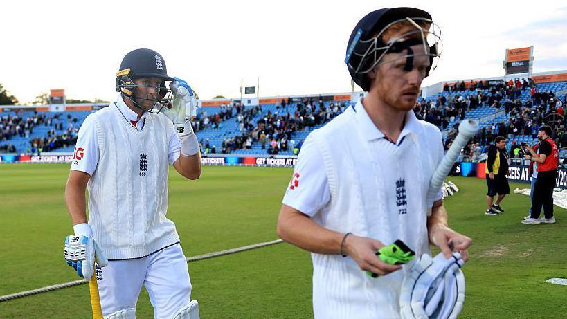 Joe Root and Jordan Cox head off the field as England closed on 112-2 in reply to Pakistan's 171 on the opening day at Headingley.