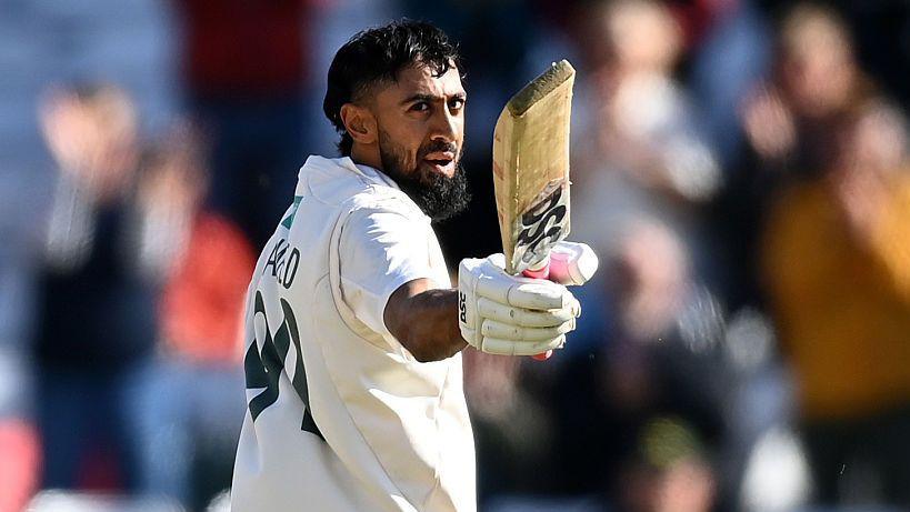 Haseeb Hameed raising his bat in celebration after reaching a century.