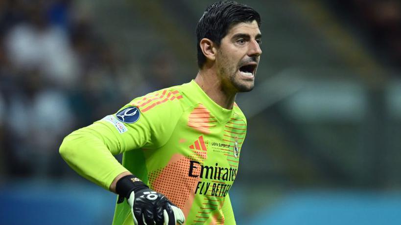 Thibaut Courtois shouts to his team-mates while playing for Real Madrid