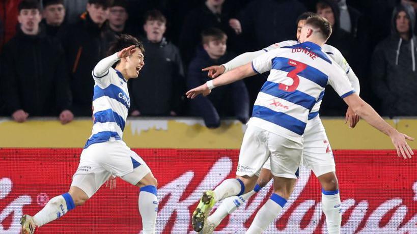 Koki Saito celebrating with his team-mates after scoring for Queens Park Rangers