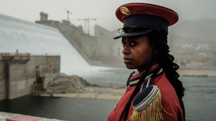 A member of Ethiopia's Republican March Band poses for photo before at the ceremony for the inaugural production of energy at the Grand Ethiopian Renaissance Dam in Guba, Ethiopia, on 20 February 2022