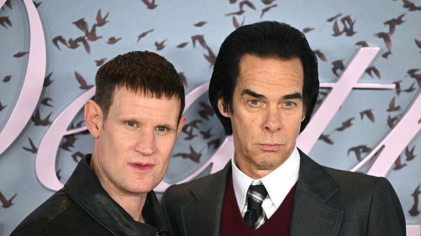 British actor Matt Smith (L) and Australian musician and author Nick Cave (R) pose on the red carpet upon arrival to attend the world premiere of TV series The Death of Bunny Munro, based on a novel by Nick Cave of the same name, at the Royal Festival Hall in London on October 30, 2025.