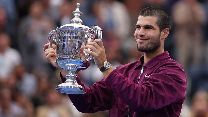 Carlos Alcaraz holds the US Open trophy