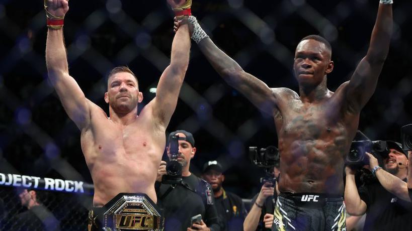 Israel Adesanya and Dricus du Plessis embrace after their bout at UFC 305 in Perth, Australia